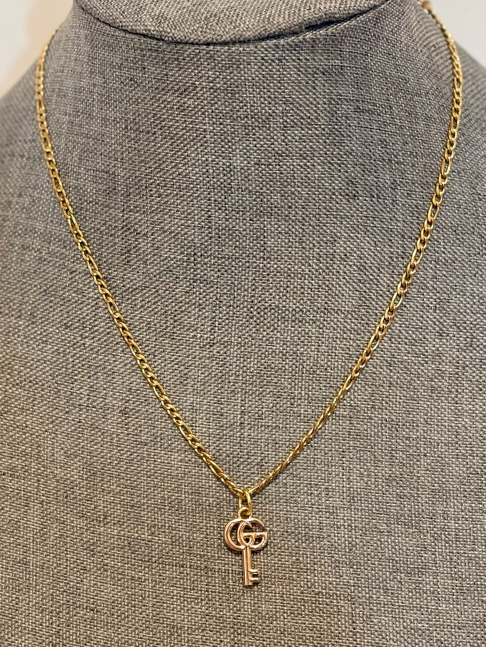Authentic Gucci key charm on 18 karat gold plated 18"chain